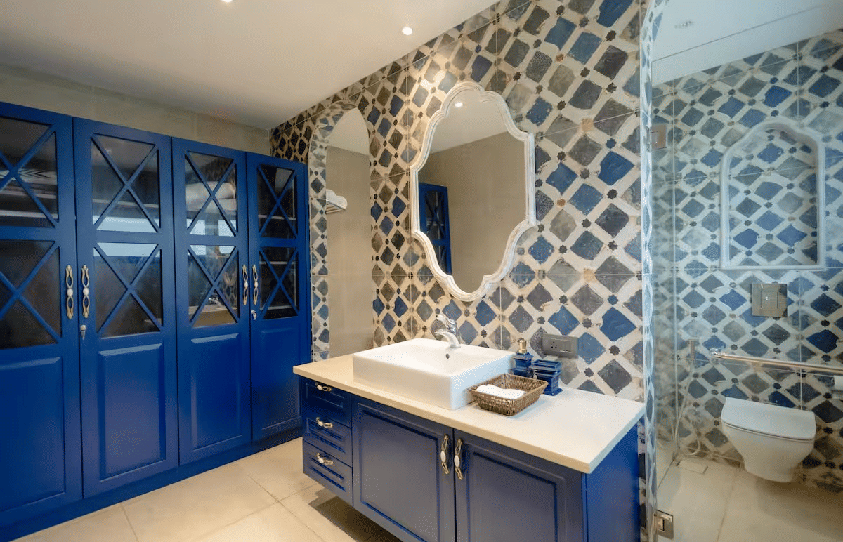 Stylish bathroom with patterned tiles and a large wall-mounted mirror above the wash basin at Lime Tree Villa with Private Pool | Luxury Stay in Goa.